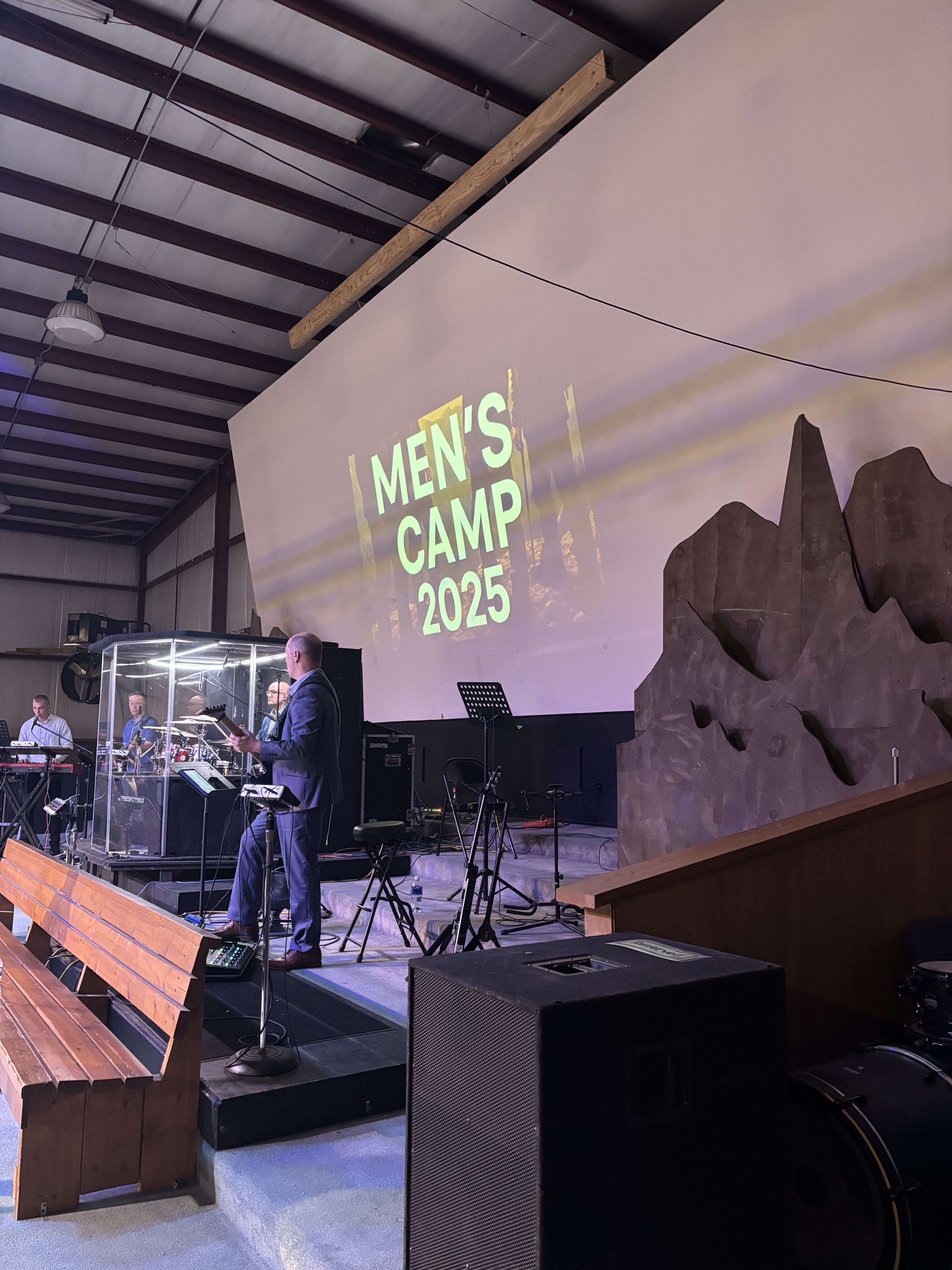Men's Camp 2025 stage with projected graphics at Wisconsin men's conference