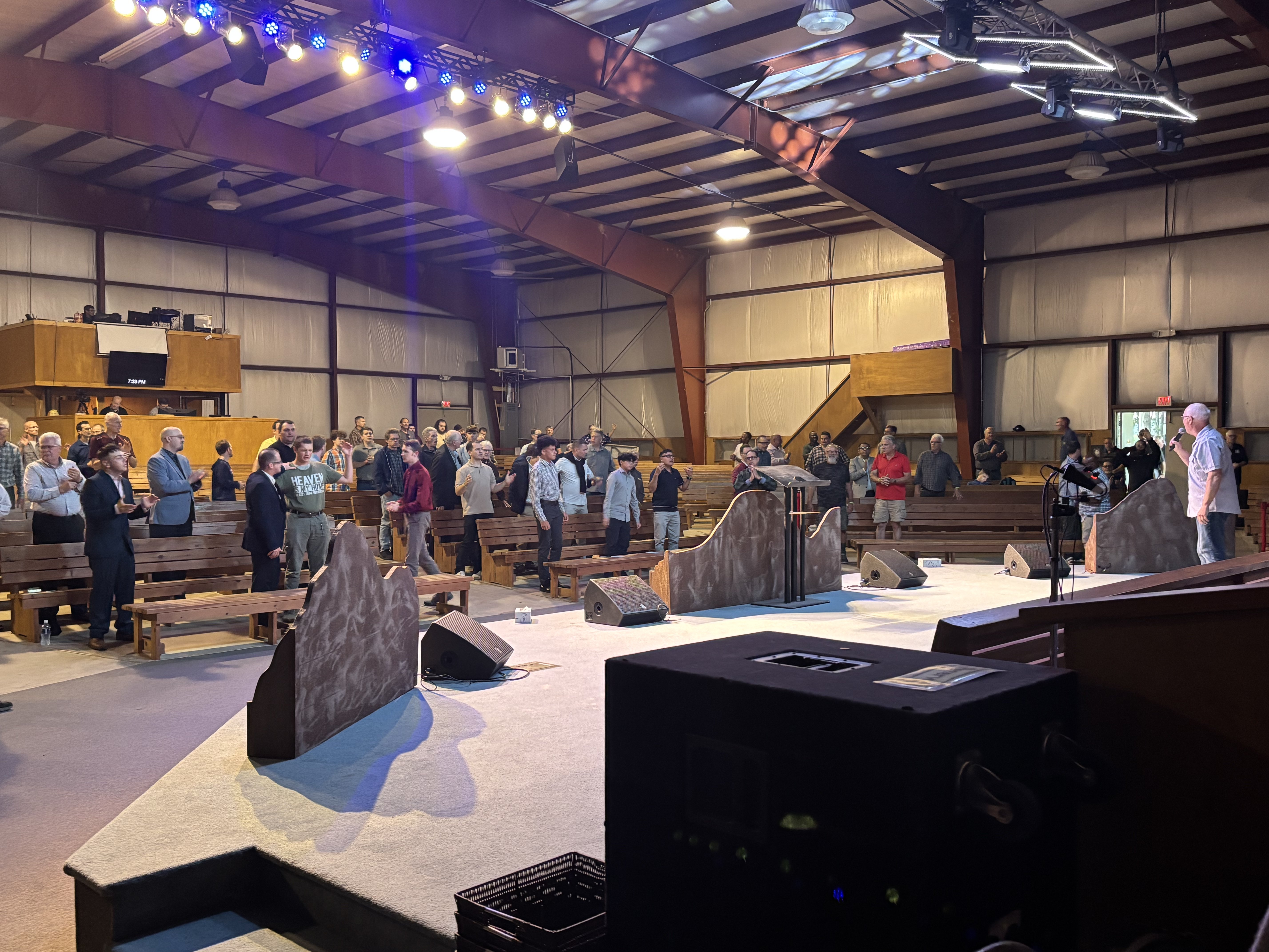 Speaker on stage addressing crowd at Wisconsin Men's Camp conference